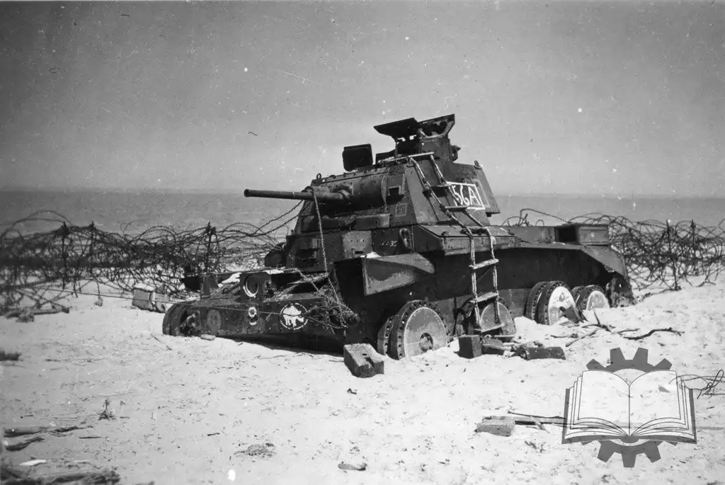 A black-and-white historical photo shows a damaged, abandoned tank stranded on a sandy beach, surrounded by barbed wire…