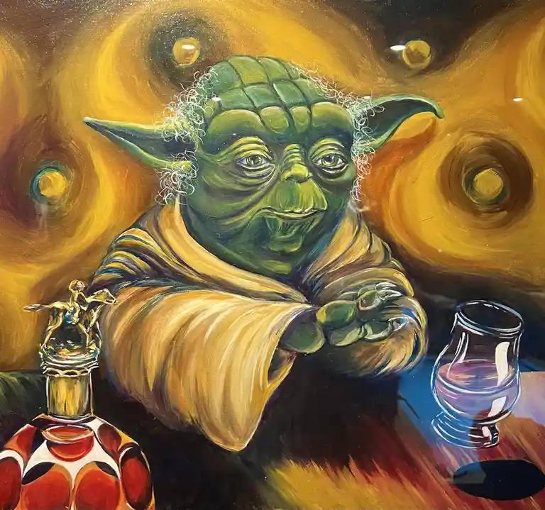 A painting depicts the Star Wars character Yoda sitting at a table with a bottle of liquor and a glass, set against a…
