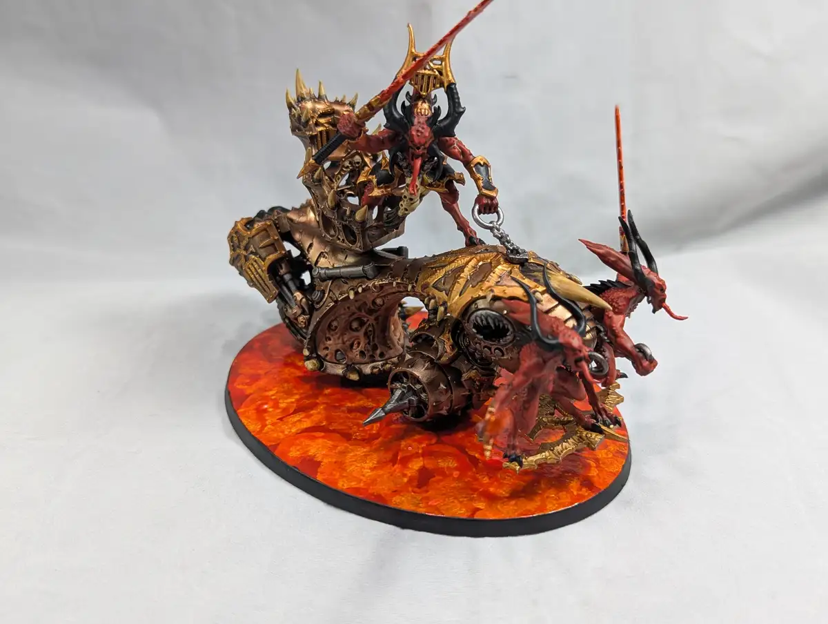 A highly detailed, hand-painted miniature of a demonic rider on a monstrous, mechanical warbike, featuring red and gold…
