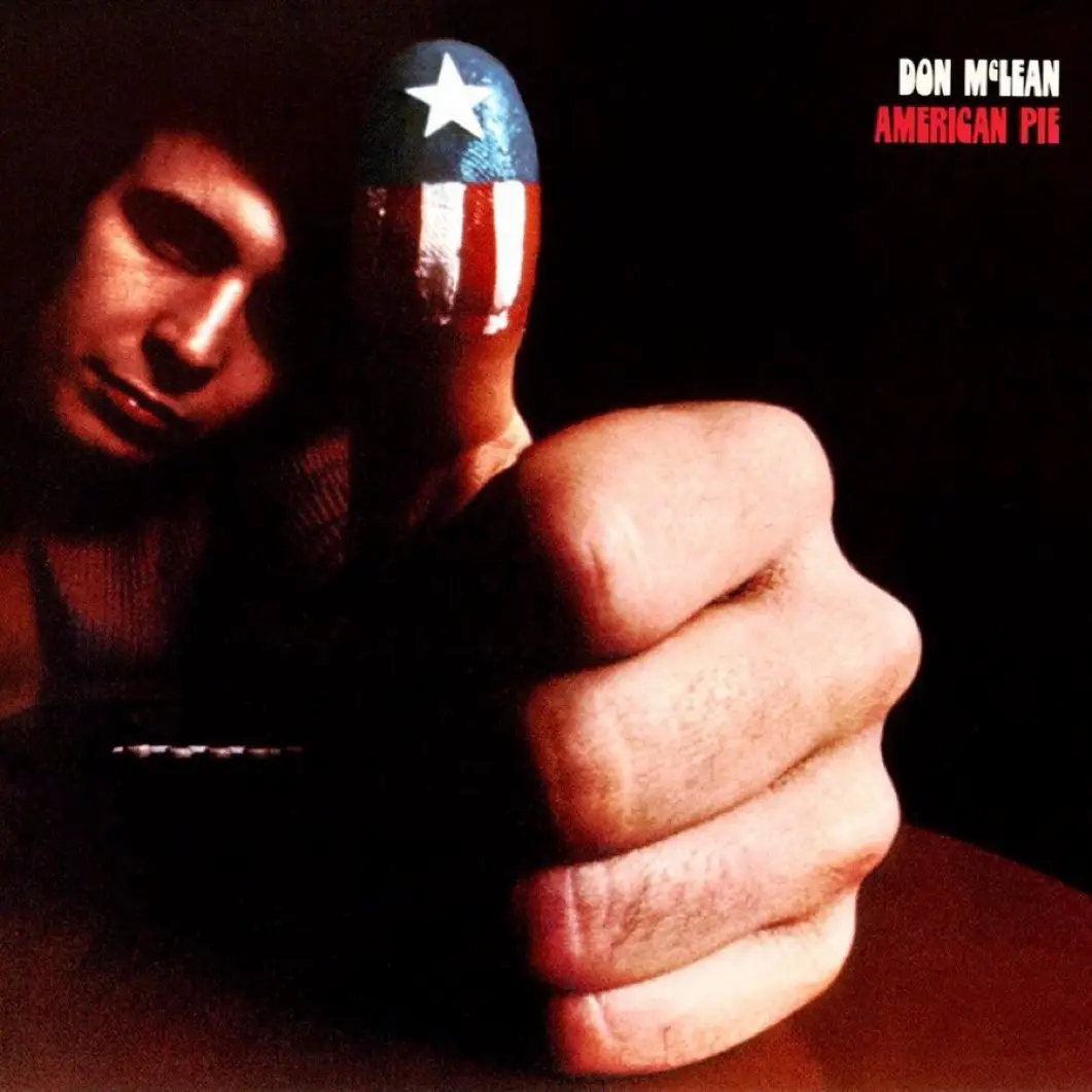 The image shows the iconic album cover for Don McLean's 'American Pie,' featuring a close-up of a man's face partially…