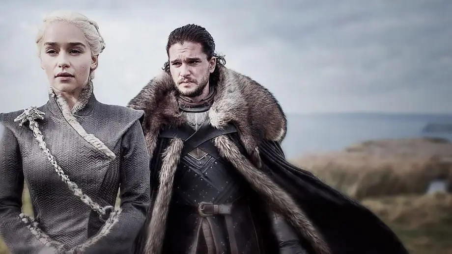 A still image from Game of Thrones shows Daenerys Targaryen and Jon Snow standing side by side in a desolate landscape…