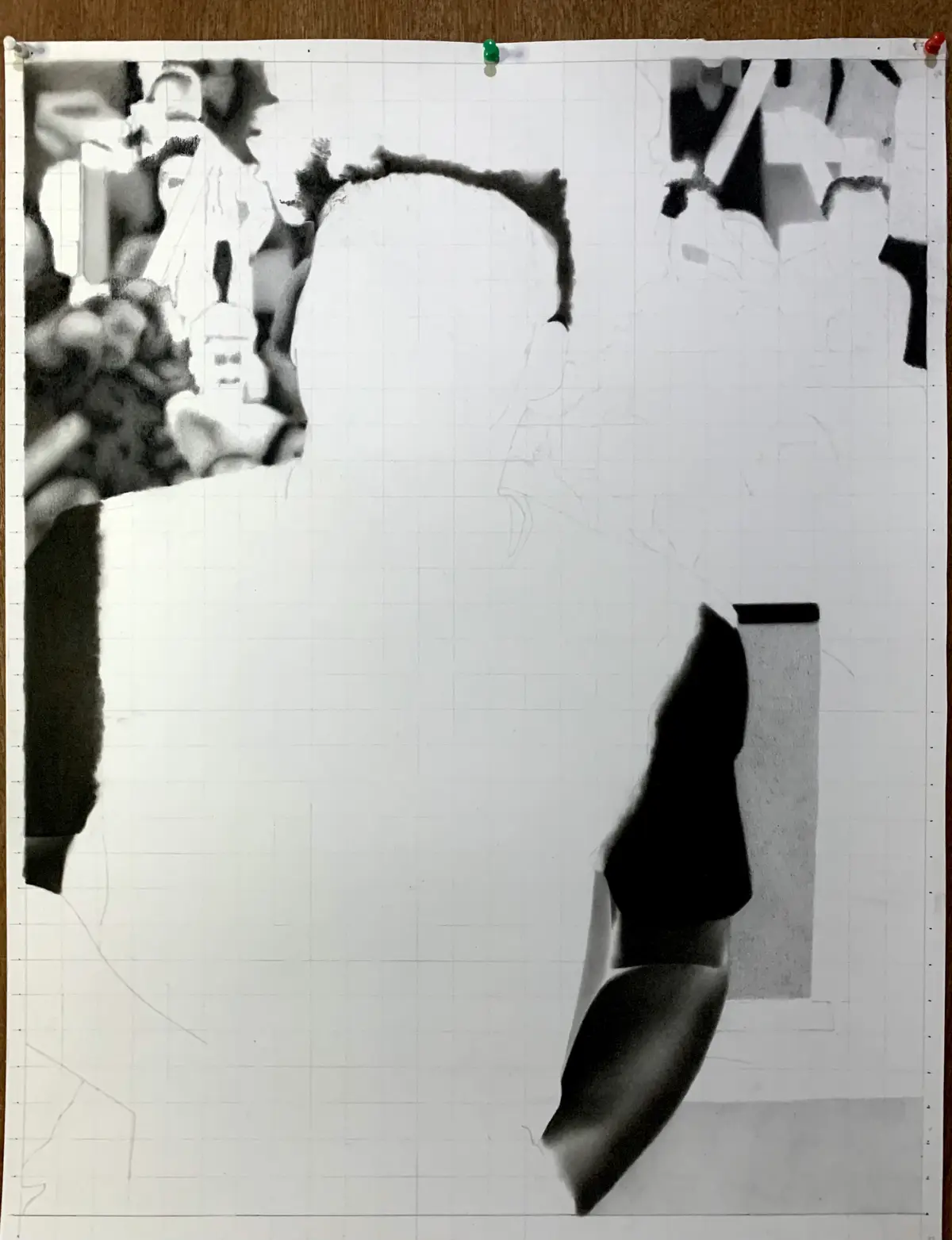 A black-and-white photo of a person's face is partially obscured by torn paper, revealing only the top of their head and…