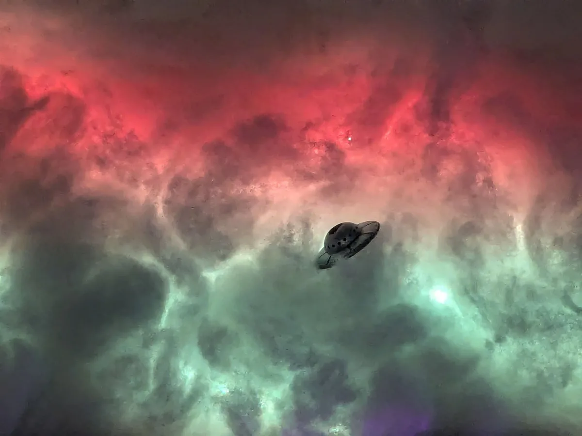 A dark, classic flying saucer UFO is centered in a cosmic nebula with swirling red and green clouds. The overlaid text reads…