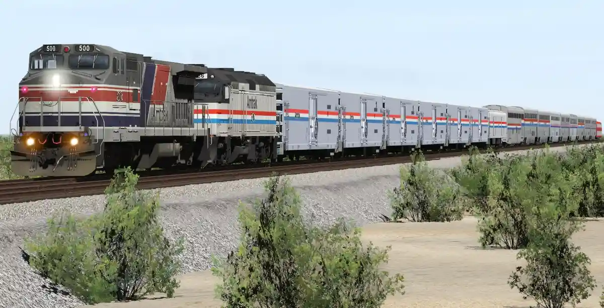 An Amtrak train with locomotive number 500 is shown traveling through a desert landscape with sparse green bushes. The train…