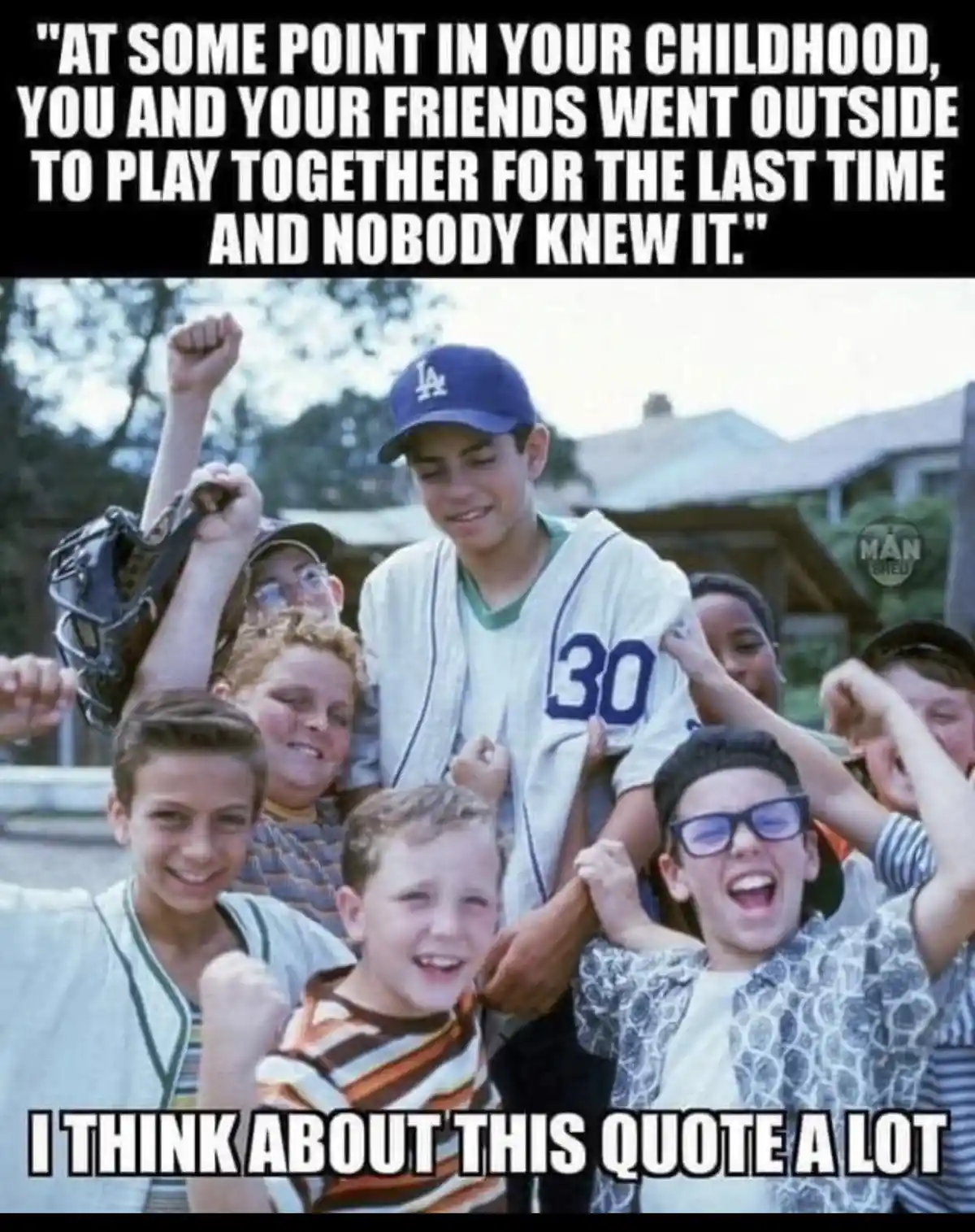 A vintage photo shows a group of smiling, excited children, mostly boys, celebrating outdoors. One boy in a baseball uniform…