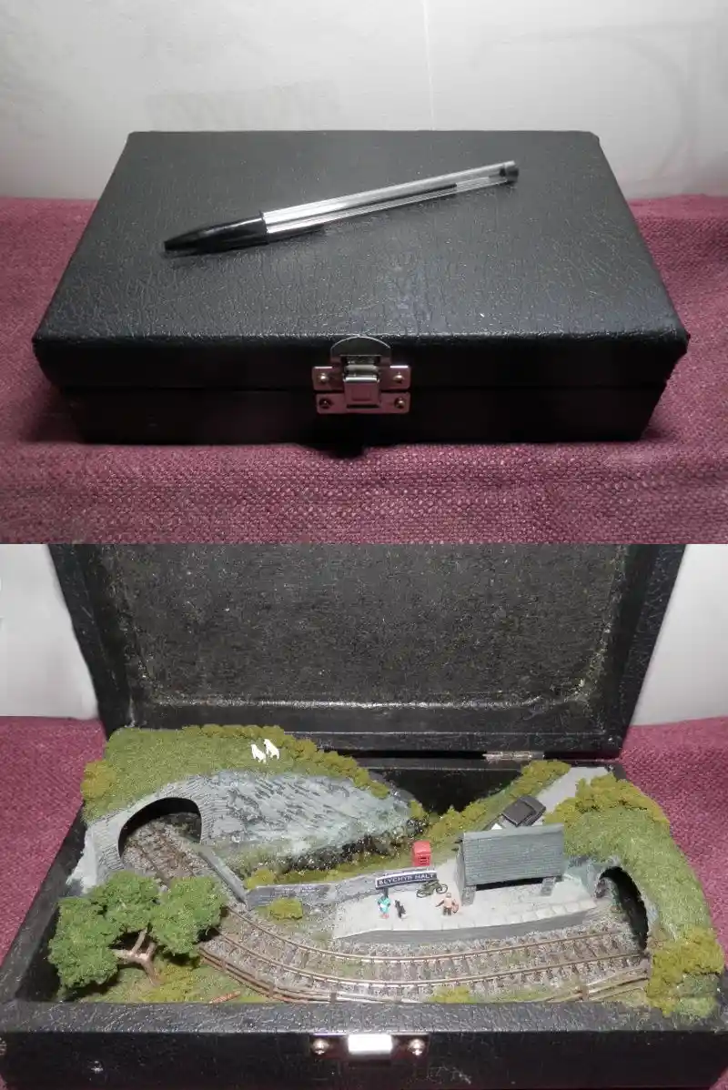 The image is split into two parts: the top shows a black textured case with a clear ballpoint pen resting on its lid. The…