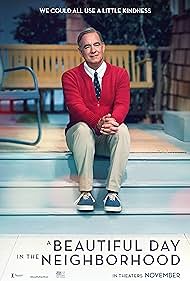 A man in a red cardigan, beige pants, and blue sneakers sits on a concrete step outdoors, smiling warmly. The image is a…