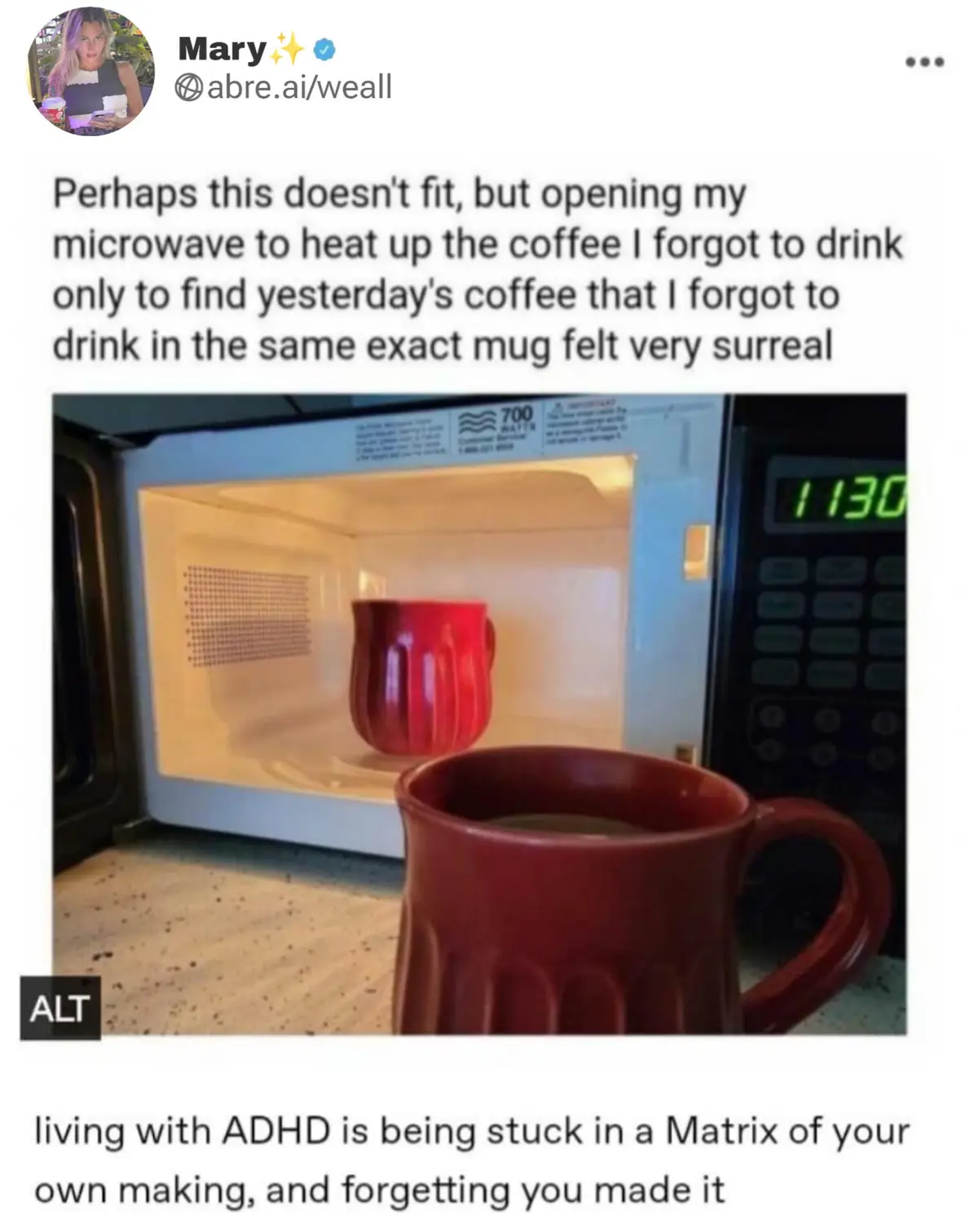 An open microwave with a red mug inside, and another identical red mug in front of it on a countertop. The overlaid text…
