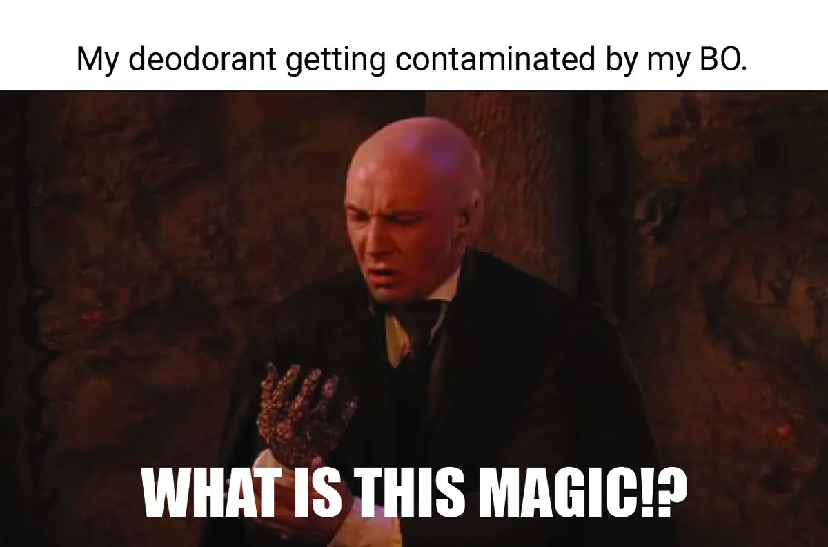 A bald man in a dark coat and bowtie looks shocked and disgusted, holding up a hand covered in glitter. The top text reads…