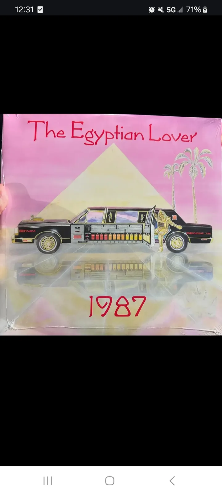 An album cover for 'The Egyptian Lover' from 1987, featuring a black limousine with a Roland synthesizer panel on its side…