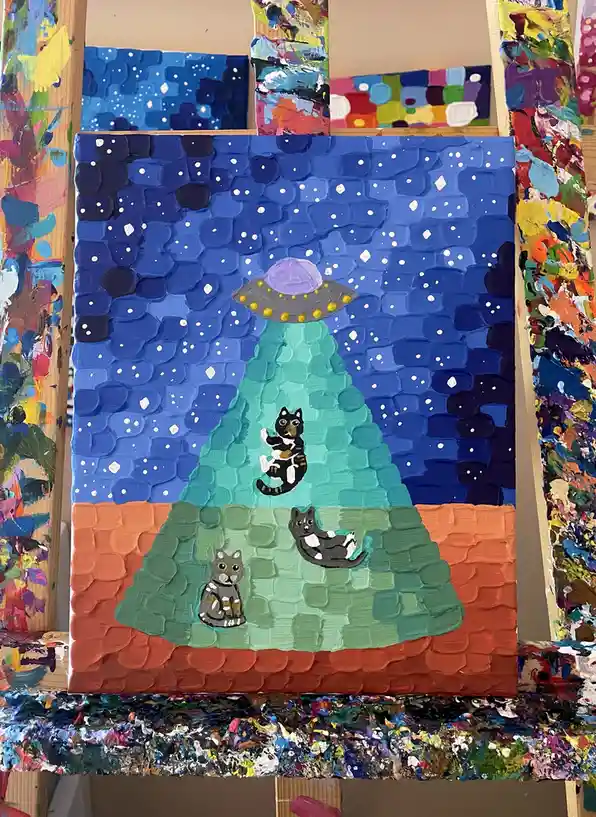 A textured, thickly painted canvas depicts a UFO beam illuminating three cats on the ground, with a starry night sky above…
