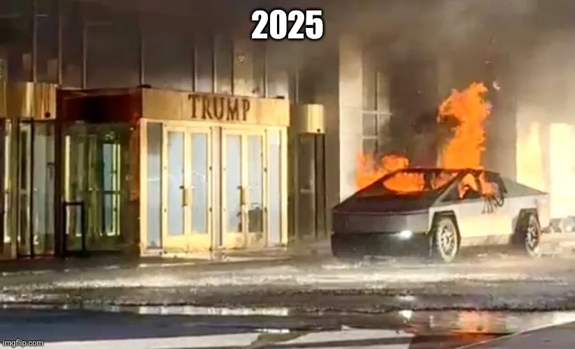 A Tesla Cybertruck is engulfed in flames next to a building with a prominent 'TRUMP' sign above its entrance. The year…
