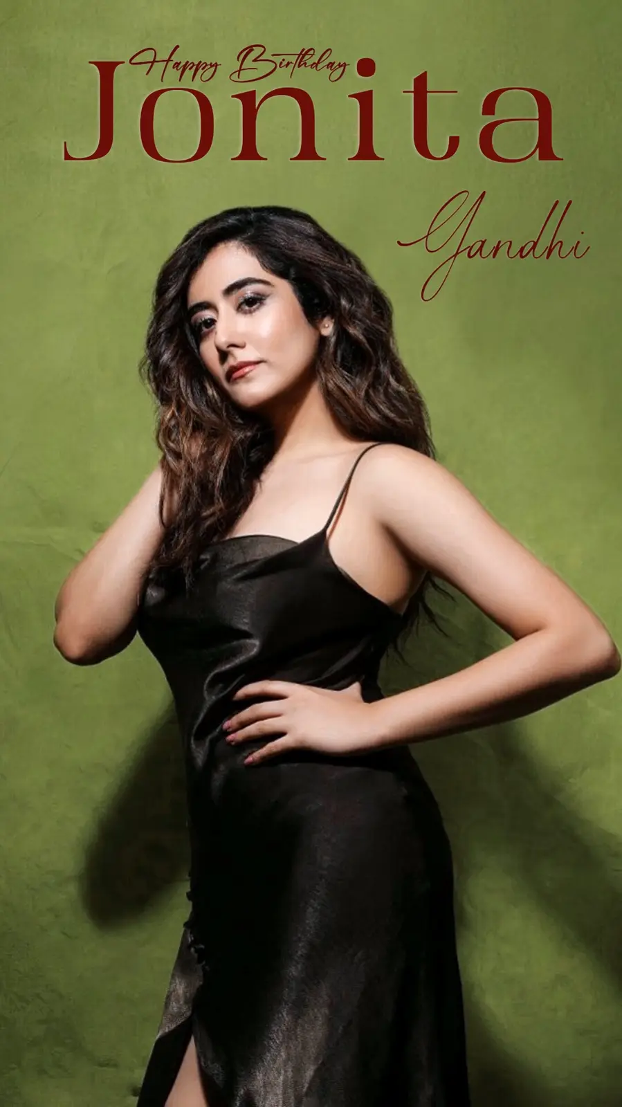 A woman with long dark wavy hair wearing a black satin slip dress poses against a solid green background. Overlaid text in…