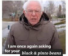 A man with white hair and glasses, wearing a brown hooded jacket, stands outdoors in a snowy or muddy area. He appears to be…