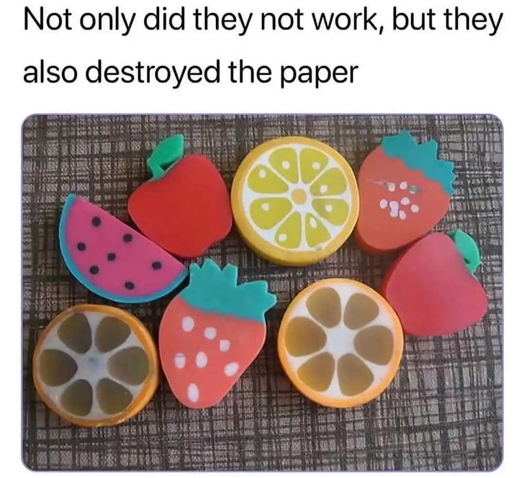 The image shows several fruit-shaped erasers on a textured surface, including watermelon, apple, strawberry, and lemon…