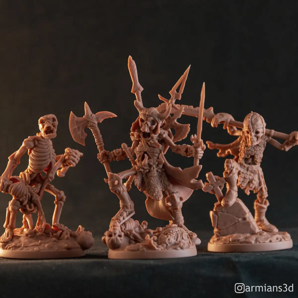 Three unpainted 3D-printed fantasy miniatures of skeletal warriors, one central figure wielding multiple weapons and flanked…