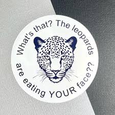 A circular white sticker features a black line drawing of a leopard's face. The text around the edge reads 'What's that? The…