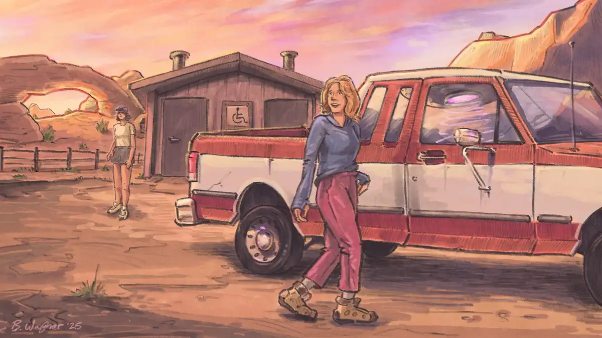 A desert scene with a red and white pickup truck parked near a building marked with a wheelchair accessibility symbol. A…