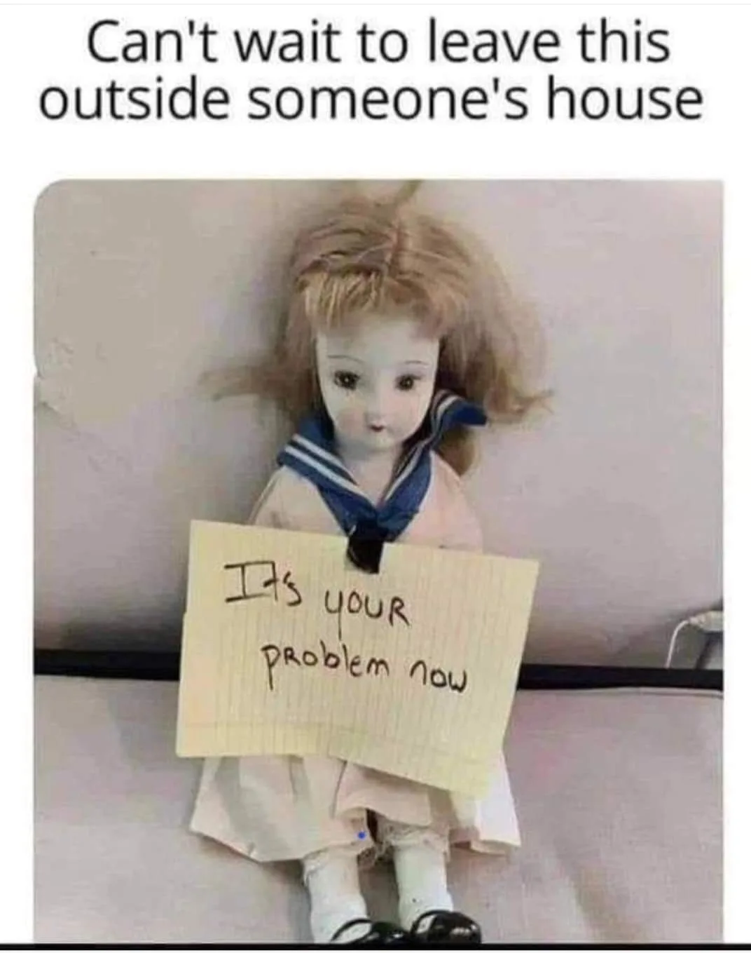 A vintage-style doll with blonde hair and a sailor collar holds a handwritten sign that reads 'It's your problem now'. Above…