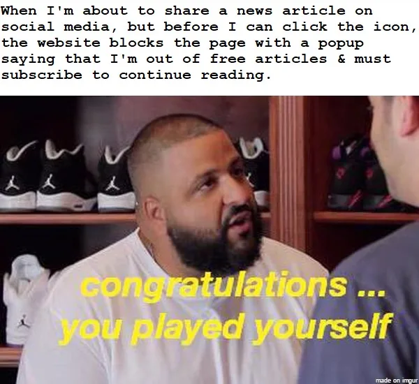 A man with a shaved head and beard, wearing a white t-shirt, looks at another person off-screen with a resigned expression…