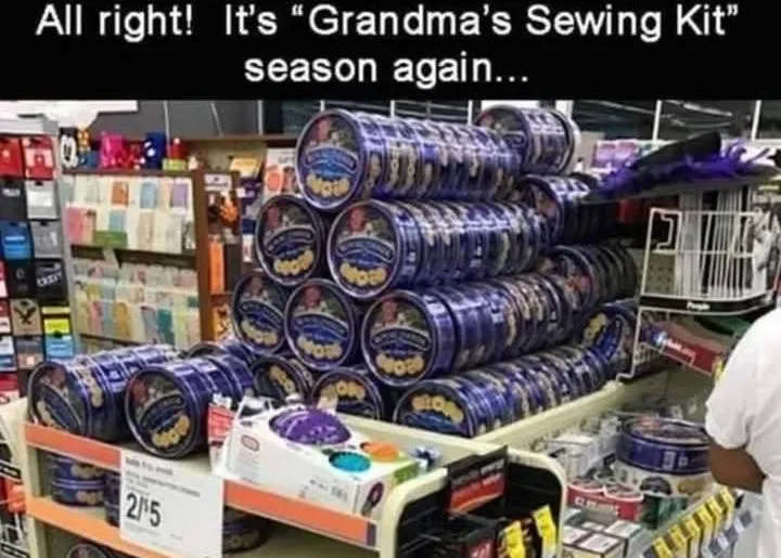 A store aisle displays a large pyramid of blue "Grandma's Sewing Kit" products, stacked high on a shelf. The overlaid text…