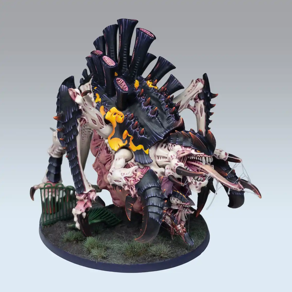 A highly detailed, grotesque fantasy monster miniature with multiple limbs, skeletal features, and a crown of dark, fleshy…