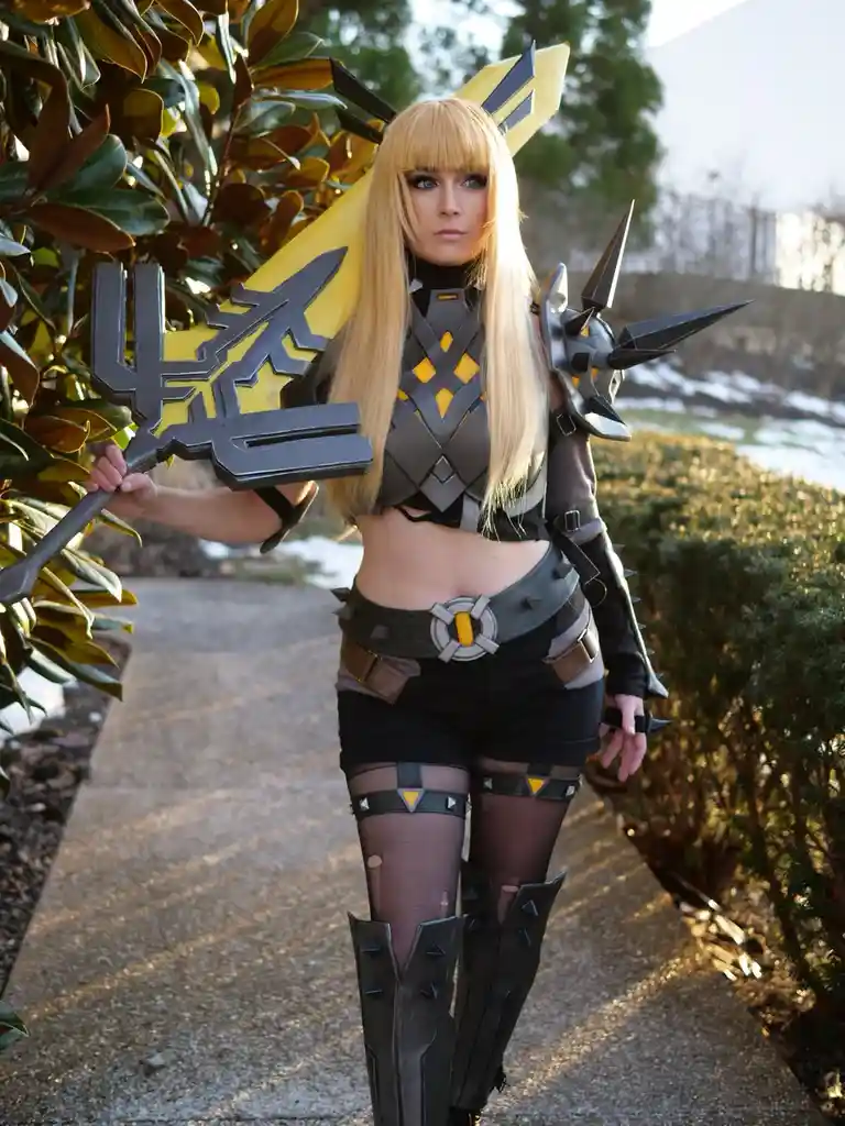 A person in a detailed cosplay of the video game character Sombra from Overwatch, holding her signature weapon, stands…