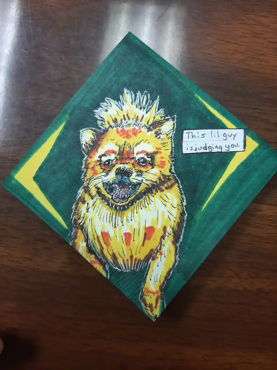 A hand-drawn illustration of a small, fluffy yellow dog with a spiky mohawk-like mane and red-orange markings on its face…