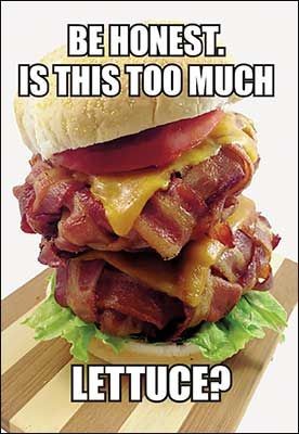 A towering, heavily layered burger with multiple strips of bacon, melted cheese, tomato slices, and a single leaf of lettuce…