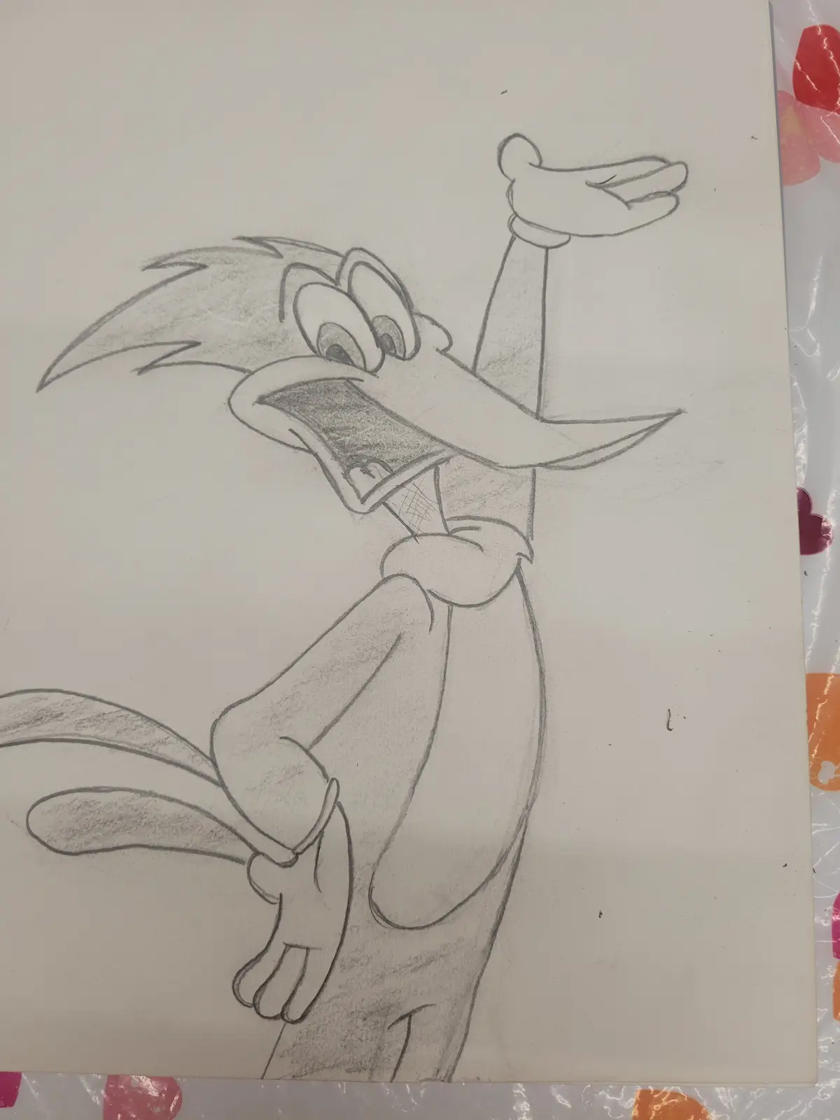 A pencil sketch of the cartoon character Wile E. Coyote shows him with a wide-open mouth, one arm raised in a gesture of…