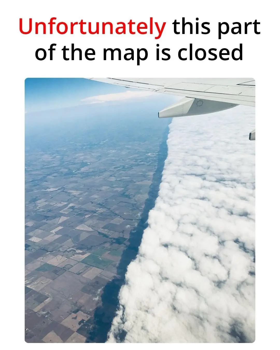 An aerial view from an airplane window shows a wing extending over a landscape of patchwork farmland below, sharply divided…
