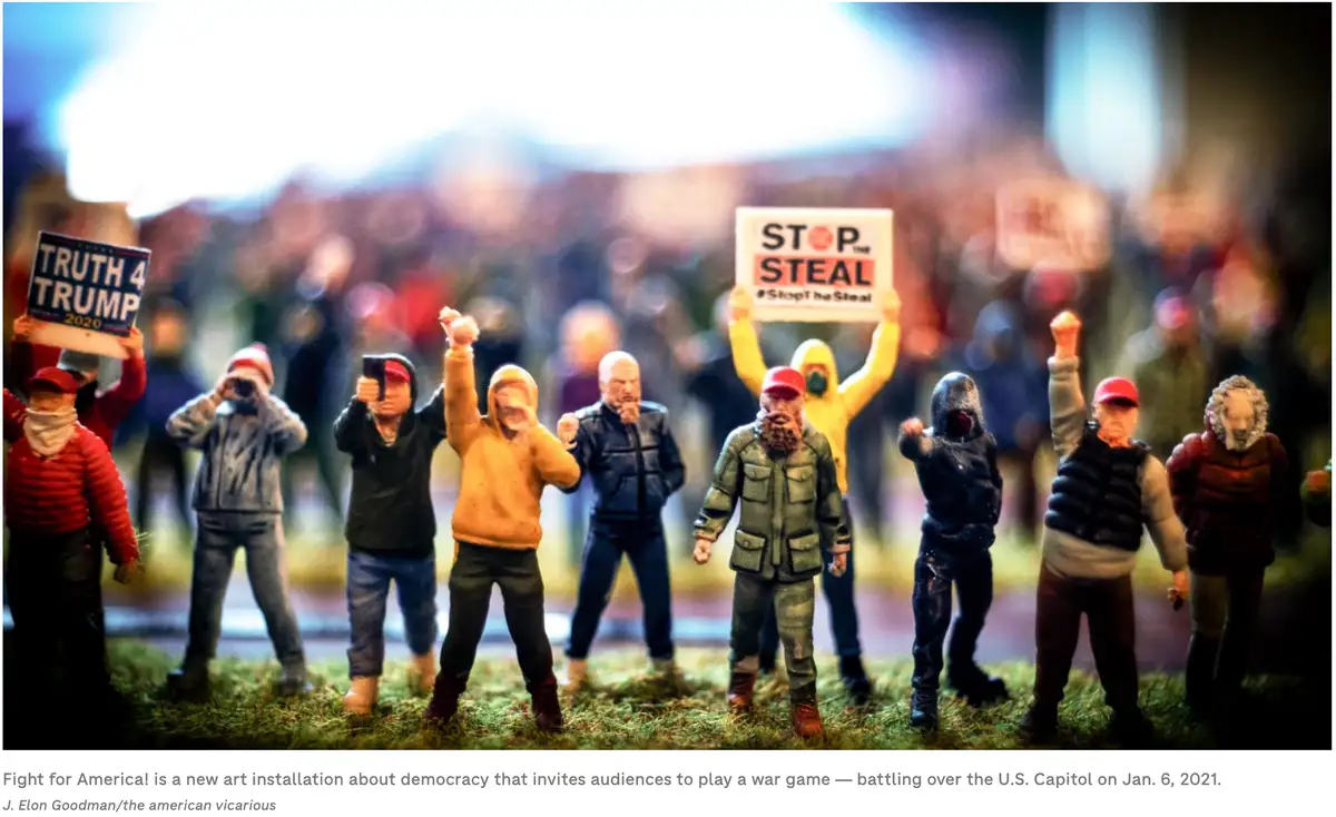 A photo shows miniature figurines of protesters, some holding signs that read 'TRUTH 4 TRUMP 2020' and 'STOP THE STEAL…