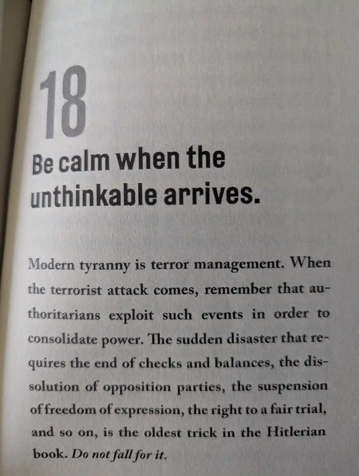 A close-up of a book page showing the number 18 and the text 'Be calm when the unthinkable arrives.' Below, a paragraph…