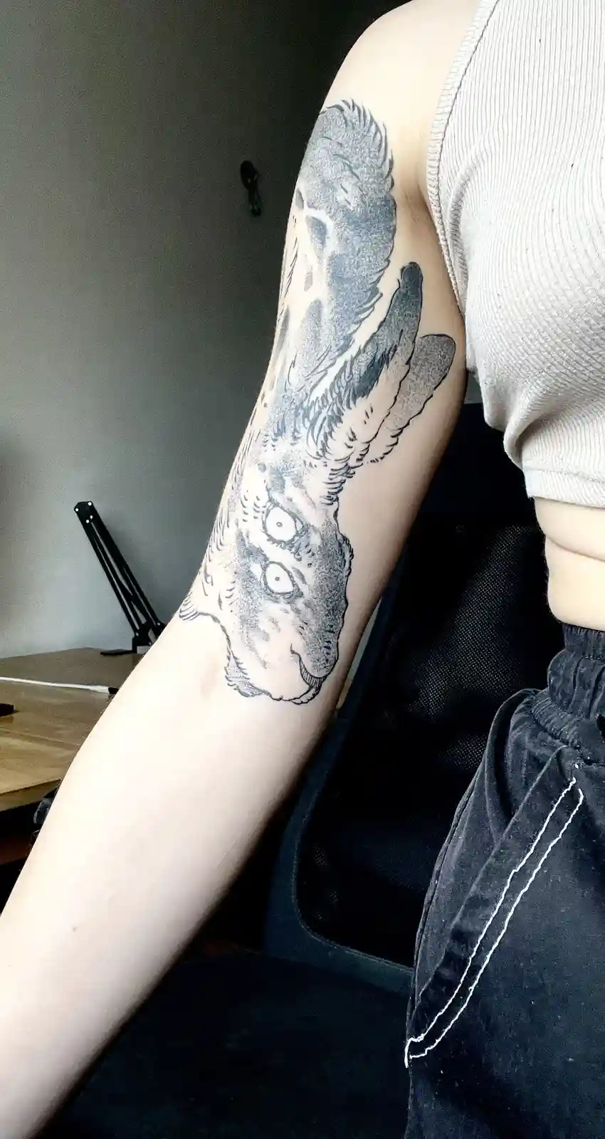 A person's left arm displays a detailed black-and-gray tattoo of a rabbit with wide, terrified eyes and an open mouth…