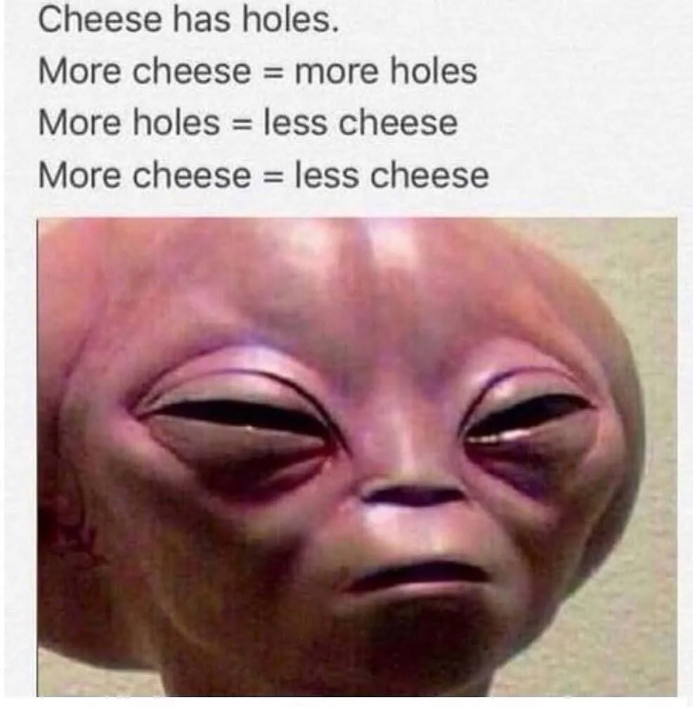 The image shows a close-up of a rubbery, pinkish alien head with large, almond-shaped eyes and a neutral expression…