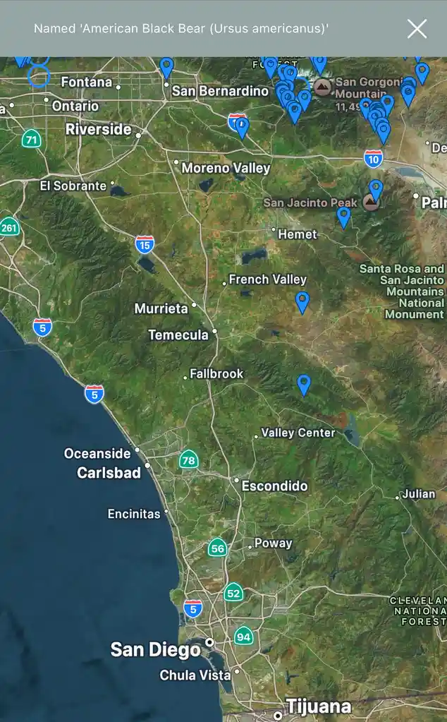 A satellite map of Southern California shows numerous blue location pins clustered in the mountains and forests, with the…