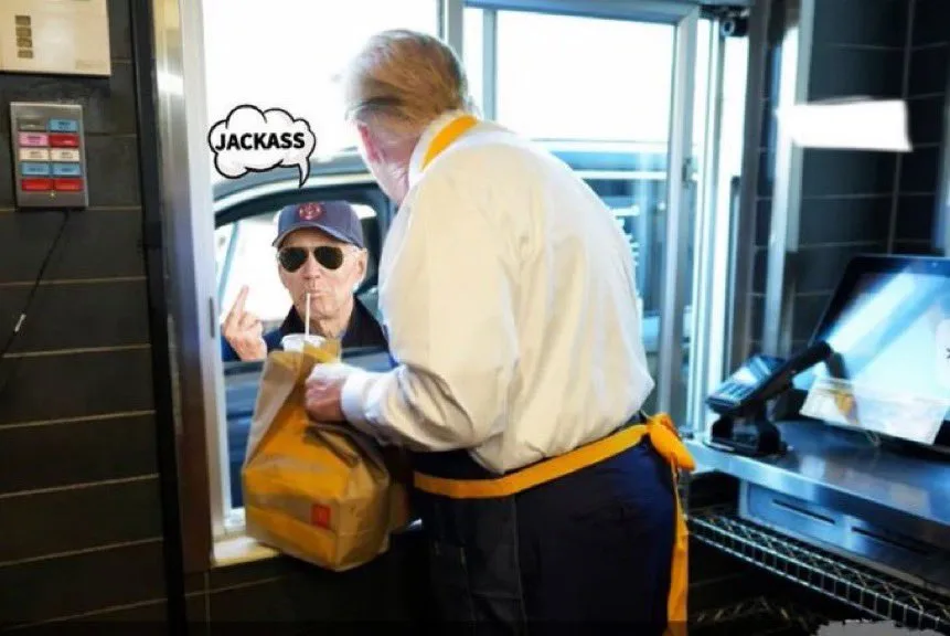 A man in a McDonald's uniform is handing a bag to a customer at a drive-thru window. The customer, wearing sunglasses and a…