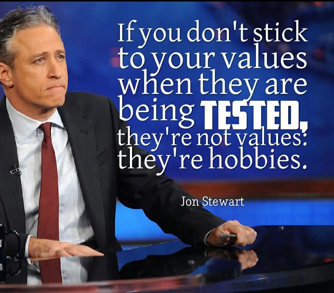 A still image of Jon Stewart in a suit and tie, seated at a desk, looking serious. Overlaid white text reads: 'If you don't…