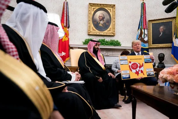In a formal room with portraits and flags, Donald Trump holds up a map of the United States with 'MAKE AMERICA GREAT AGAIN'…