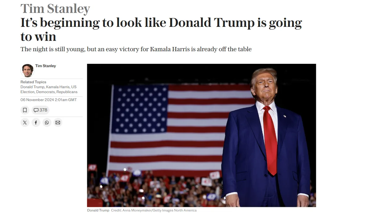 A screenshot of a news article by Tim Stanley shows a photo of Donald Trump in a blue suit and red tie standing before a…