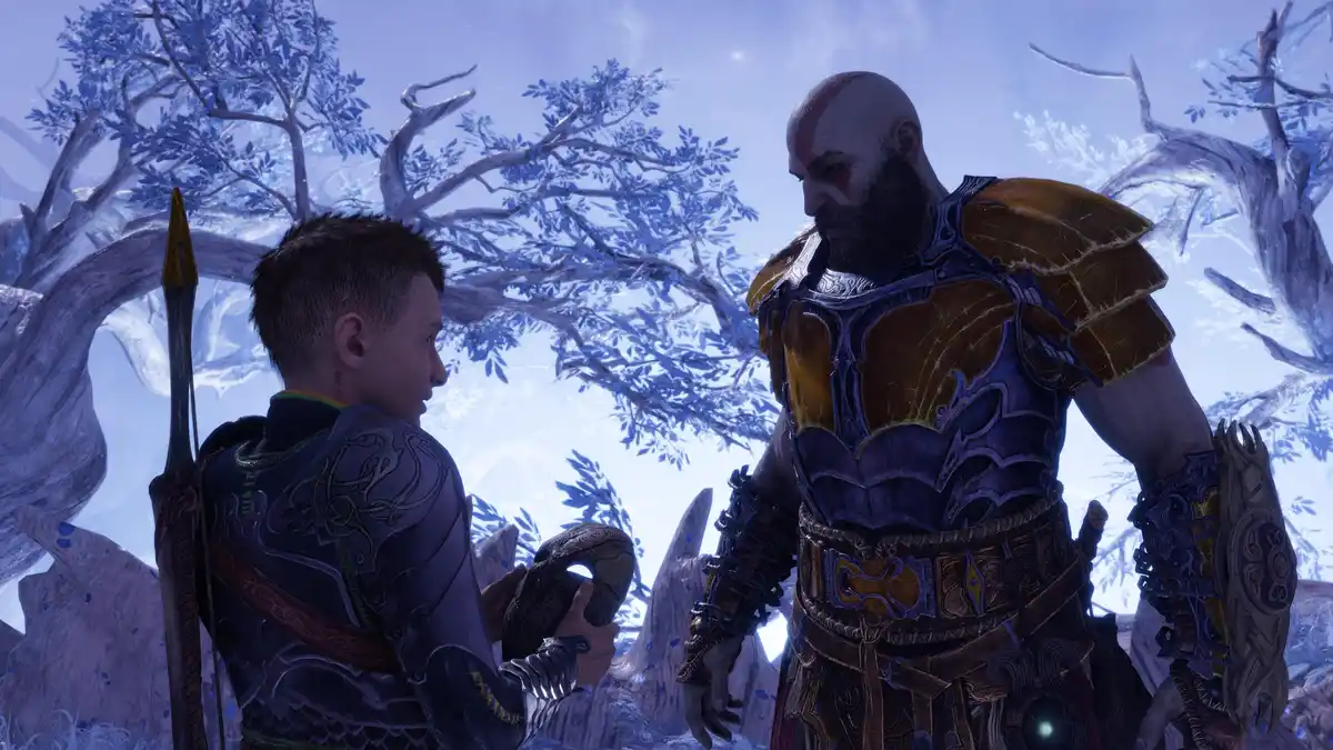 In a snowy, ethereal forest setting from the video game God of War, a young boy in dark armor holds up a small, worn object…