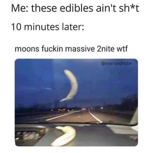 A car dashboard view at night shows a banana on the dashboard and a large, crescent-shaped moon visible through the…