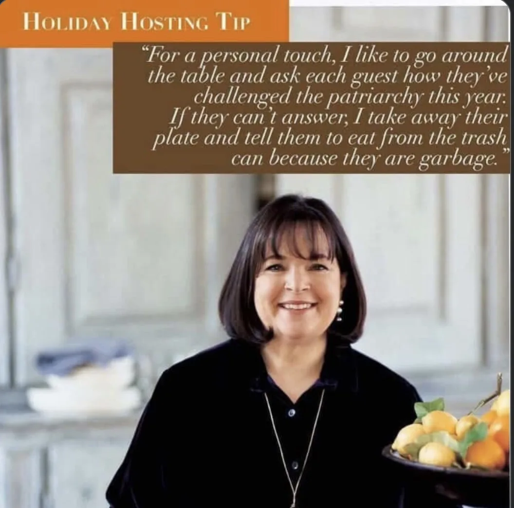 A woman with short dark hair, wearing a black shirt and necklace, smiles while holding a bowl of citrus fruits. An orange…