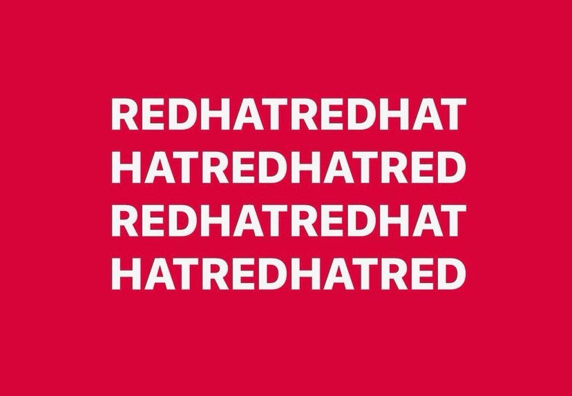 A solid red background with bold white text repeating the phrases 'REDHATREDHAT' and 'HATREDHATRED' in alternating lines…