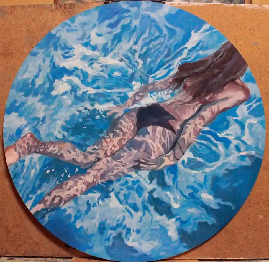 A circular painting depicts a woman with long dark hair swimming underwater in blue and white textured water, wearing a…