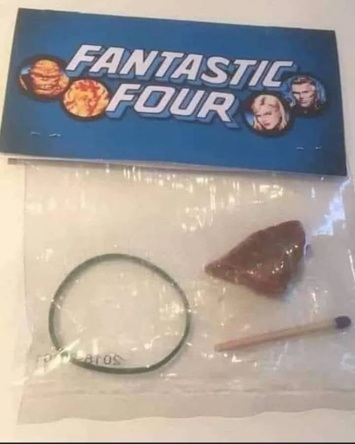 A plastic bag labeled 'FANTASTIC FOUR' with images of the four characters, contains a rubber band, a small brown rock, and a…