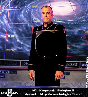A man in a black Starfleet-style uniform stands in front of a starfield display with grid lines and coordinates. The image…