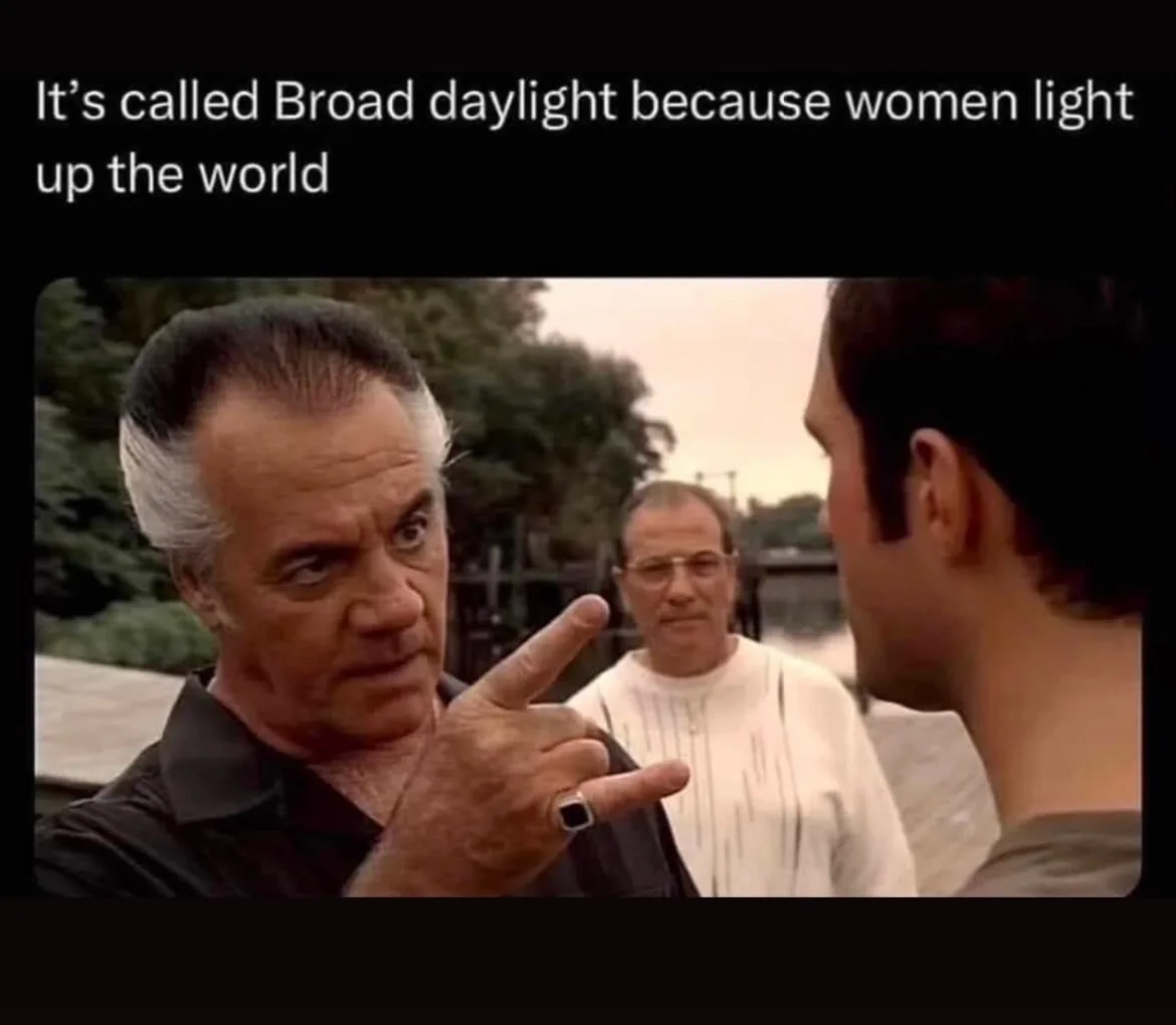 A man with white hair and a black shirt points angrily at another man while wearing a ring, with a third man in a white…