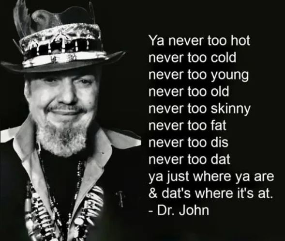 A black-and-white photo of Dr. John wearing a decorated hat and beaded necklaces, smiling. Overlaid text reads: 'Ya never…