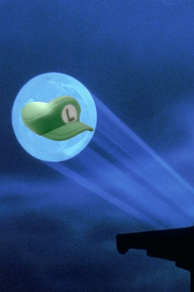 A green Luigi hat with a white 'L' emblem is superimposed on a full moon against a dark blue night sky, with beams of light…